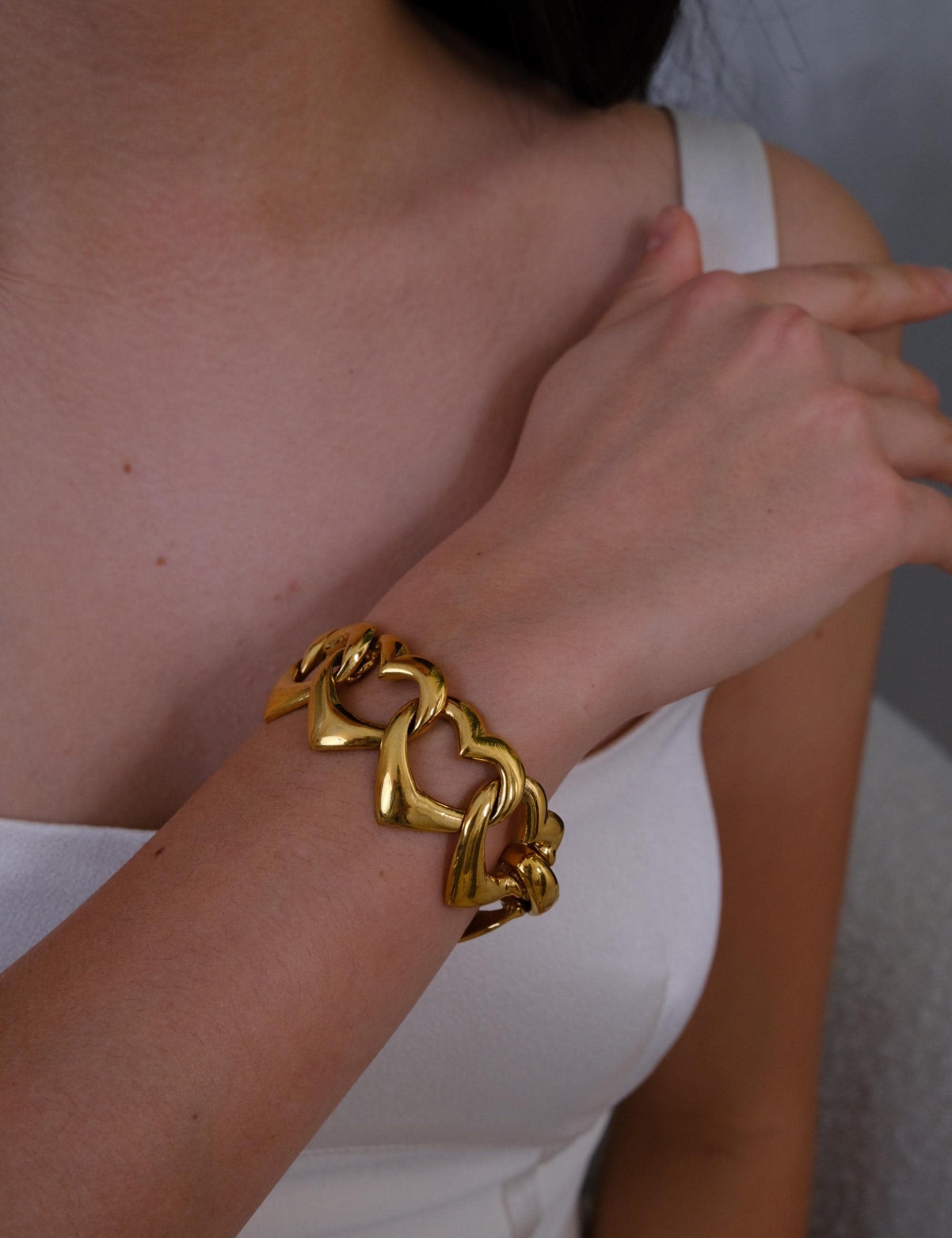 Vintage Yves Saint Laurent gold heart link bracelet with romantic luxe aesthetic