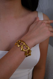 Vintage Yves Saint Laurent gold heart link bracelet with romantic luxe aesthetic