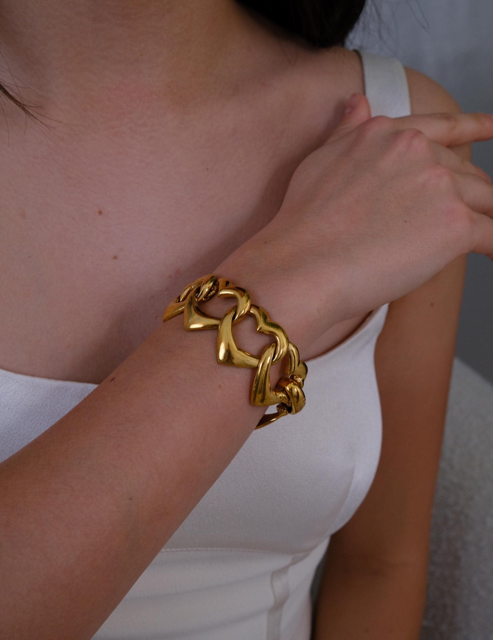 Vintage YSL gold heart bracelet with playful coquette aesthetic and bold shine