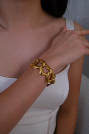 Vintage YSL gold heart bracelet with playful coquette aesthetic and bold shine