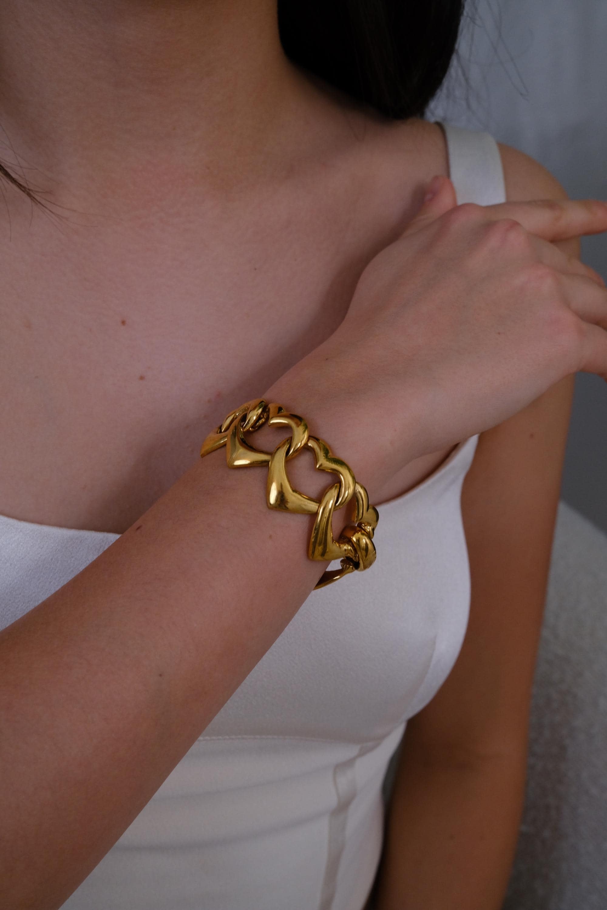 Vintage YSL gold heart bracelet with playful coquette aesthetic and bold shine