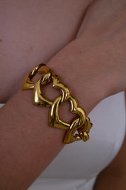 Vintage Yves Saint Laurent chunky gold heart bracelet with glam street style vibe