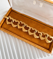 Vintage Yves Saint Laurent gold heart bracelet with bold romantic fashion vibe