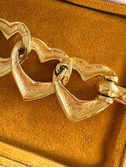Vintage Yves Saint Laurent gold heart link bracelet with romantic luxe aesthetic