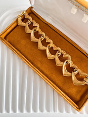 Vintage Yves Saint Laurent gold heart link bracelet with romantic luxe aesthetic