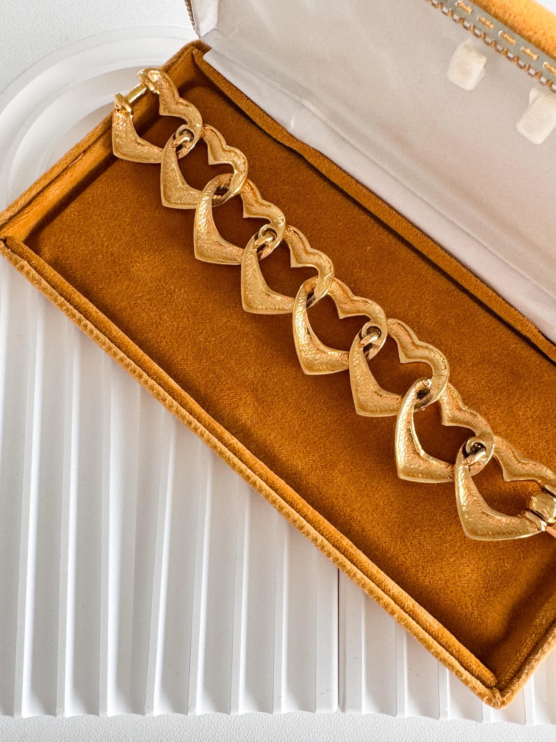 Vintage Yves Saint Laurent gold heart link bracelet with romantic luxe aesthetic