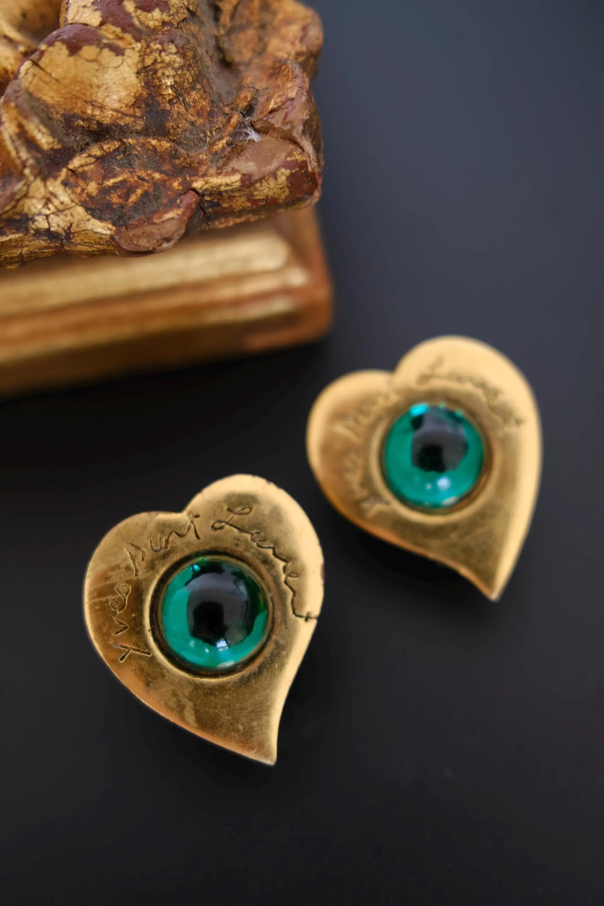 Vintage YSL emerald green cabochon earrings close-up showing internal marks
