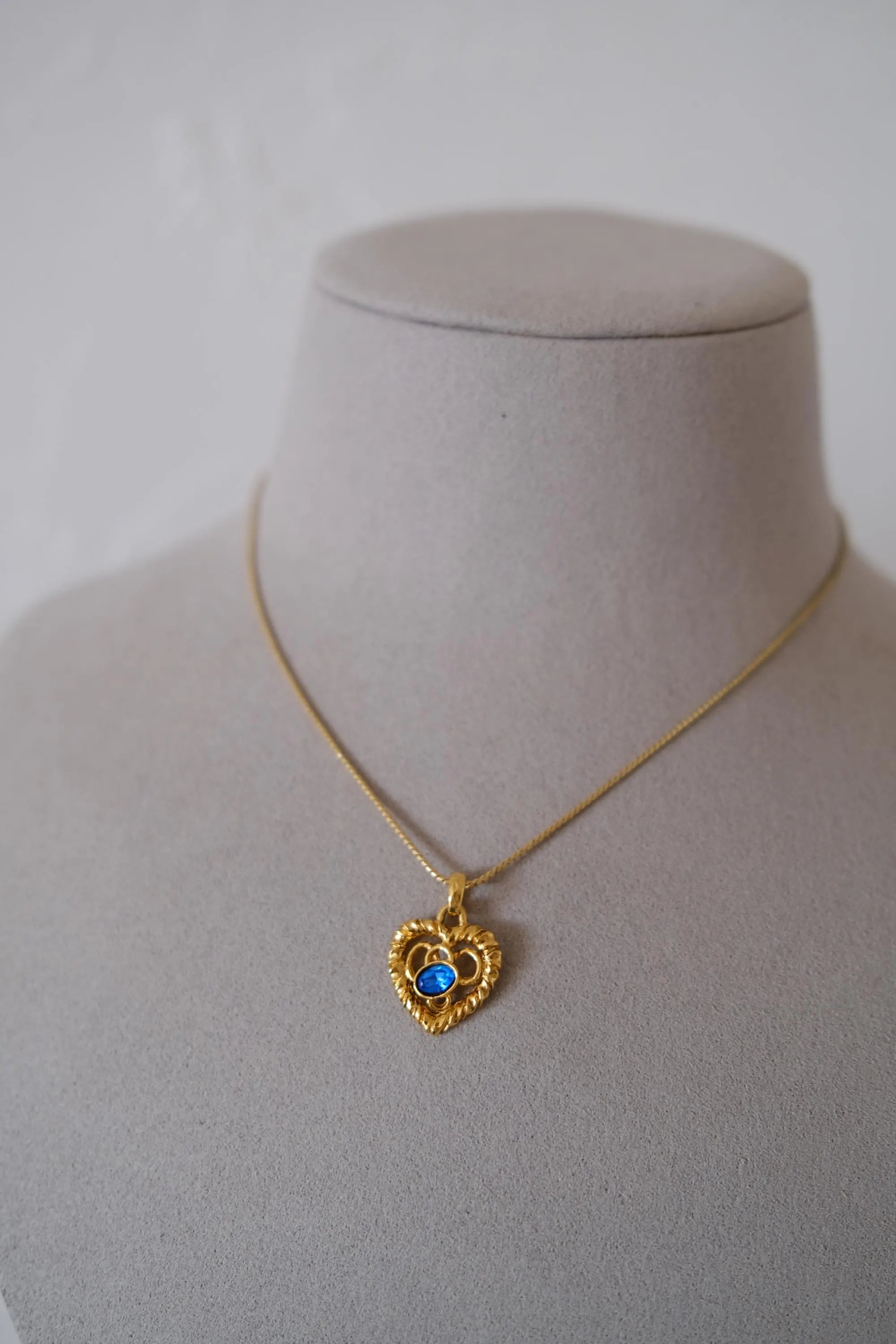 Vintage YSL Yves Saint Laurent gold-tone openwork heart pendant necklace worn around the neck