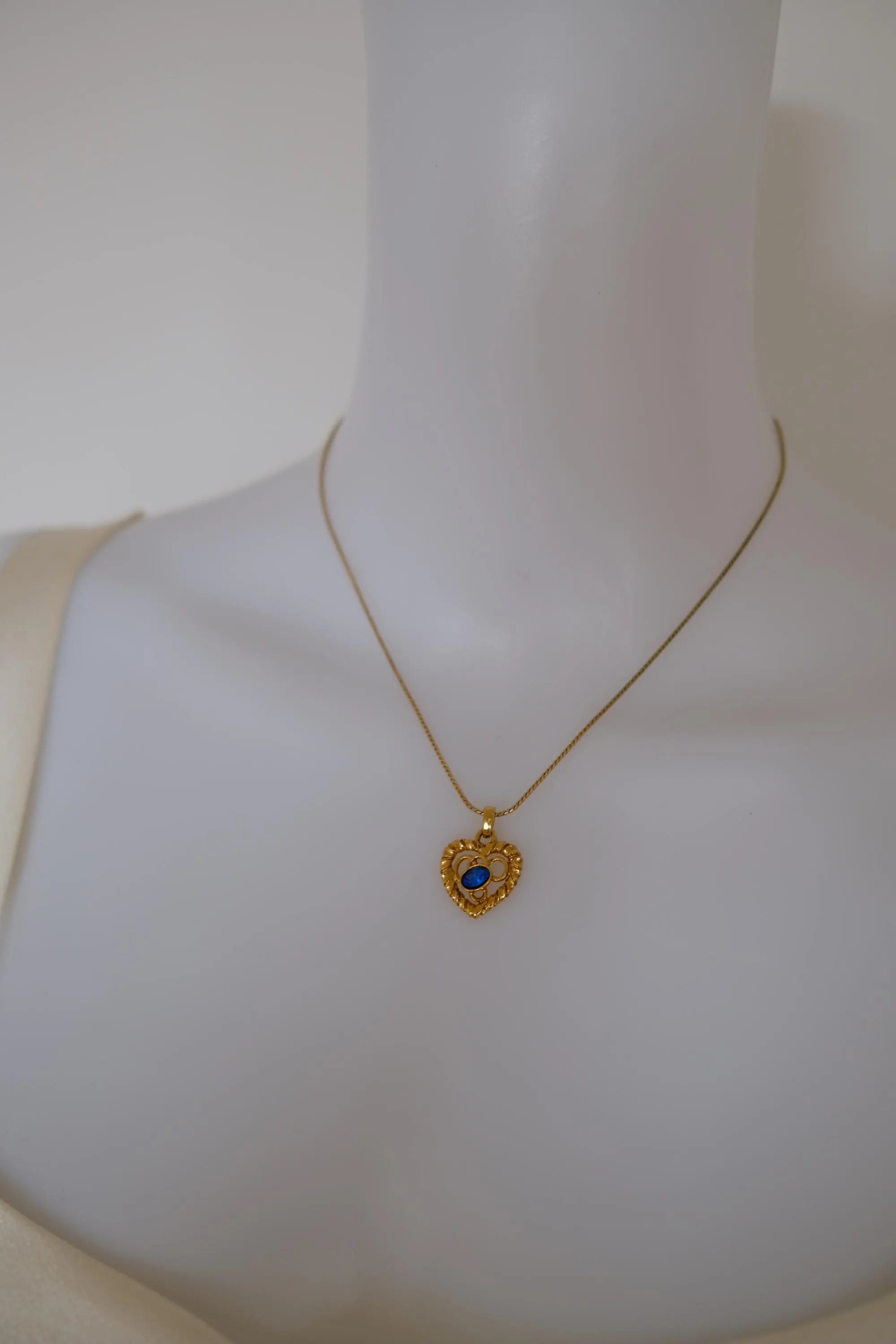 Vintage YSL Yves Saint Laurent gold-tone openwork heart pendant necklace worn around the neck