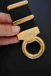 Vintage Yves Saint Laurent belt showing visible gold-tone finish wear and fading on buckle