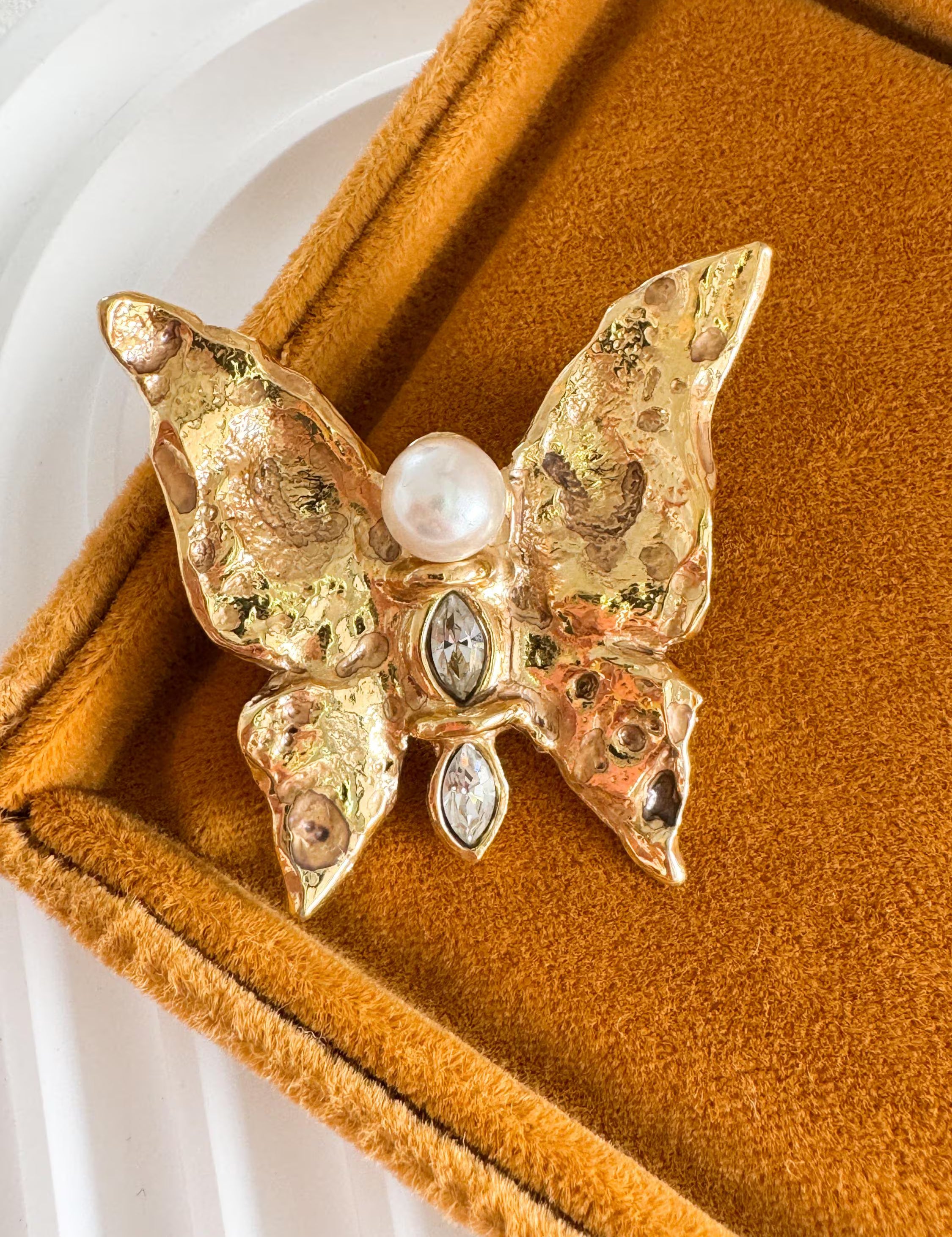 Vintage Yves Saint Laurent gold butterfly brooch with pearl and rhinestone accents, timeless couture elegance