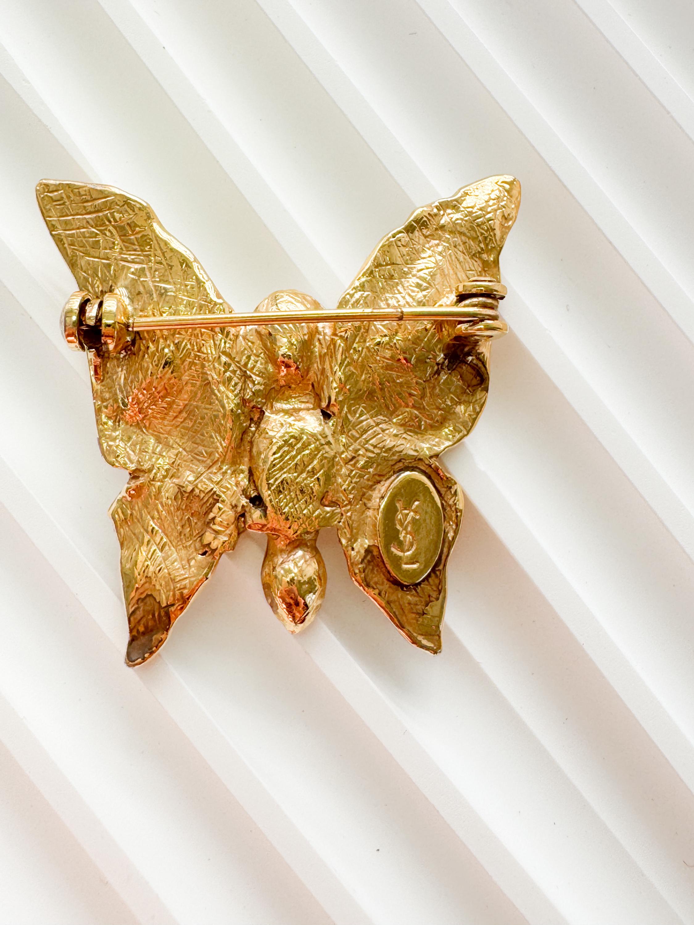 Vintage Yves Saint Laurent gold butterfly brooch with pearl and rhinestone accents, timeless couture elegance