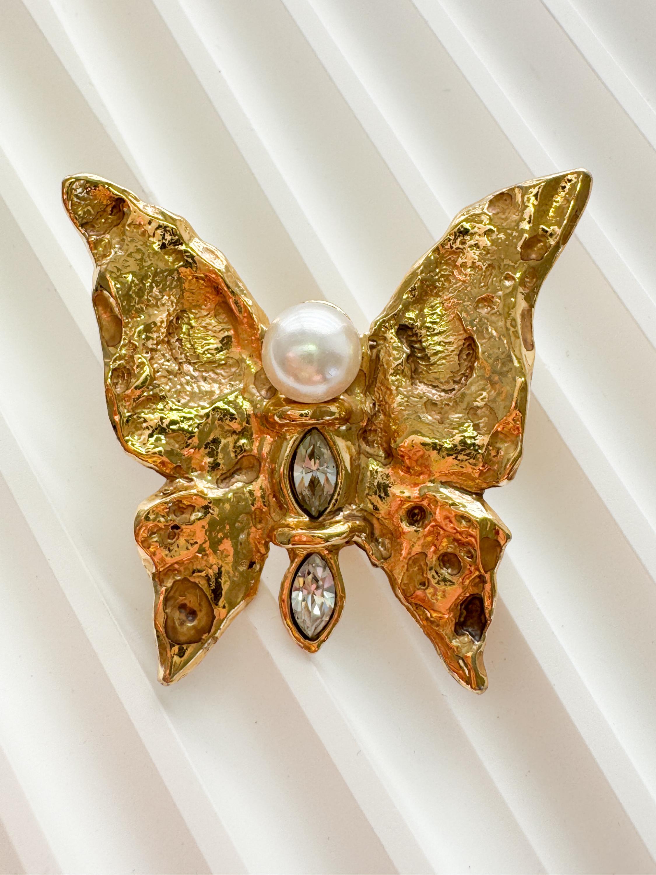 Vintage Yves Saint Laurent gold butterfly brooch with pearl and rhinestone accents, timeless couture elegance