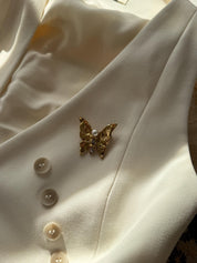 Vintage YSL gold butterfly pin with pearl and rhinestones, elegant and timeless designer accessory