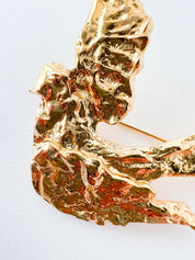 Close-up of vintage YSL dove bird brooch in gold tone