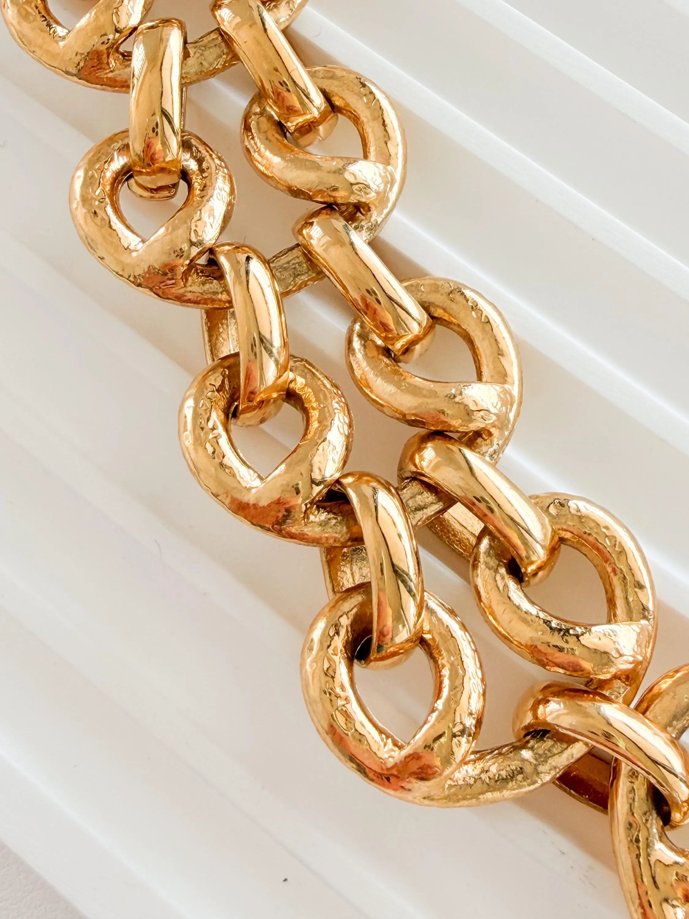 Close-up of chunky gold link chain on vintage YSL statement necklace