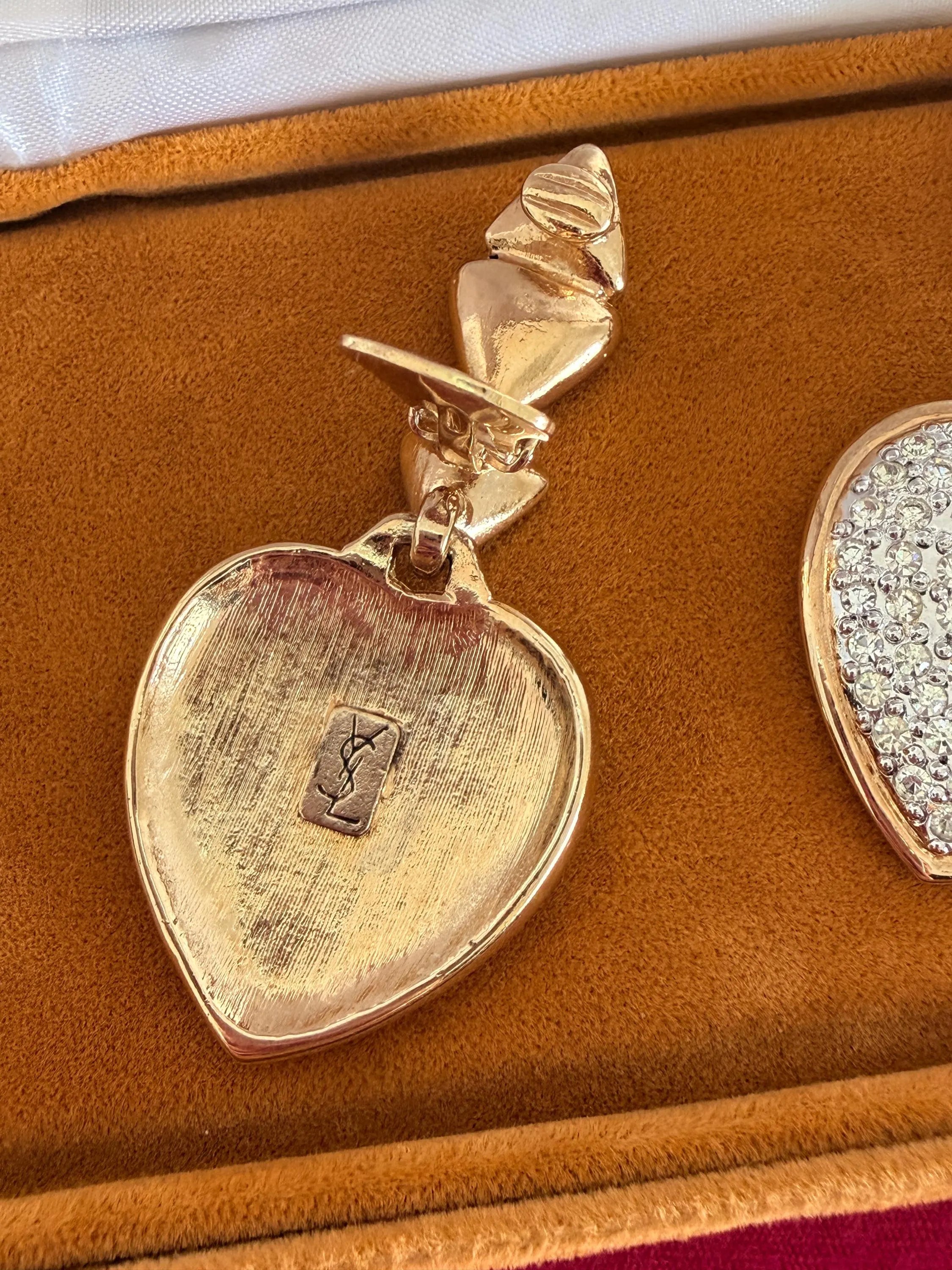 Close-up of sparkling pave crystals on vintage YSL heart earrings