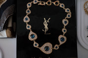 Vintage YSL Yves Saint Laurent heart necklace with blue cabochon and crystal accents in gold tone